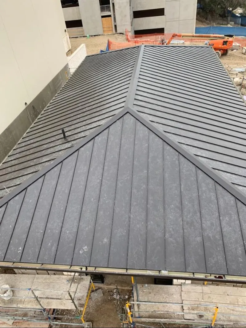 Commercial metal roof construction with crane equipment in Chartiers